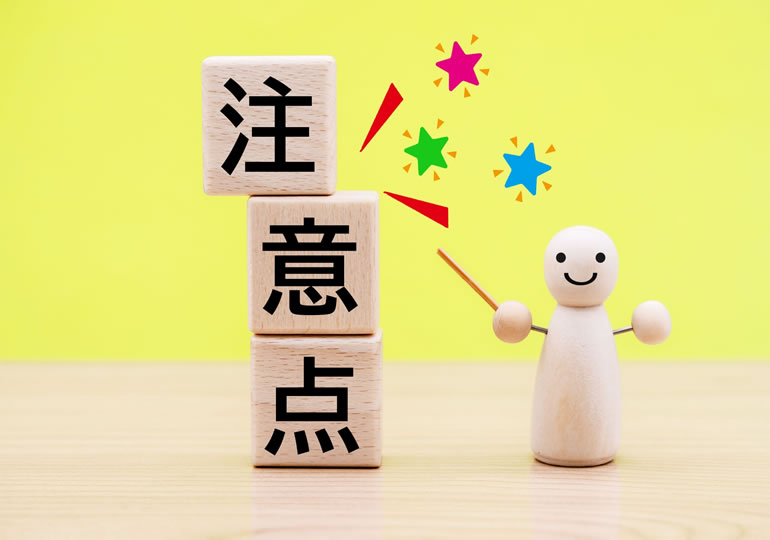 注意と書かれた木彫りの人形