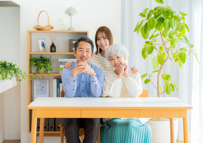 リビングでくつろぐ高齢夫婦と娘