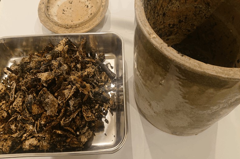 汚れた遺骨を専用のトレーに移した画像